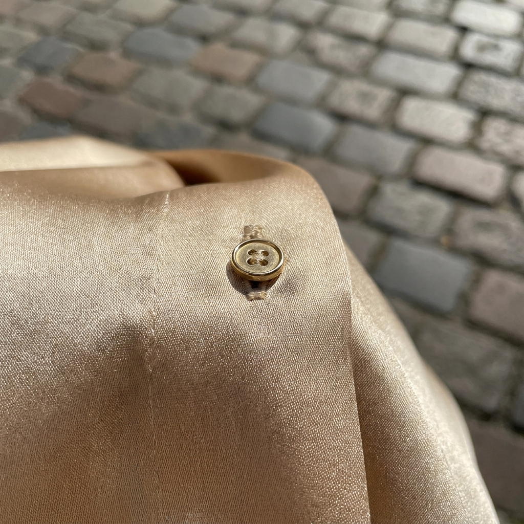Gold elegant sleeveless blouse with buttons fabric close-up